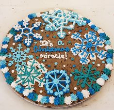 a cake with frosting and snowflakes that says it's christmas miracle