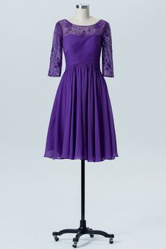 a purple dress on a mannequin with lace sleeves and an open neckline