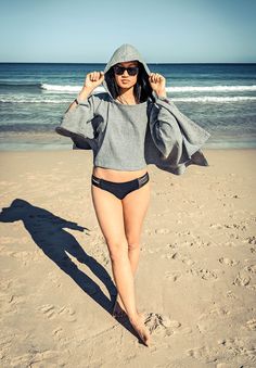 Our Hooded Crop Towel goes from a towel to a contemporary crop fit top. The long sleeves and hood protects from the chilly sea breeze. When in use as a towel, the hood covers the neck so no sand gets on top of the towel or on you!  This style is lightweight and super cozy. Simply throw on over your swimsuit and style with a pair of shorts or high waist denims for a chic and effortlessly on-trend look. 100% cotton, Designed in Australia, Made in Turkey.  Quick Drying, tight weave so the sand won' Sporty Long Sleeve Sweatshirt For The Beach, Sporty Hooded Sweatshirt For The Beach, Sporty Long Sleeve Beach Hoodie, Beach Hooded Sweatshirt With Drawstring Hood, Beach Sweatshirt With Drawstring Hood, Beach Hoodie With Drawstring Hood, Hooded Towels, Top Les, Hooded Towel