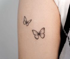 two butterflies tattoo on the left arm