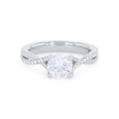 a white gold engagement ring with diamonds on the band and a single round diamond in the center