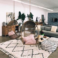 a living room filled with lots of furniture and decor on top of a white rug