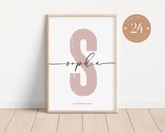 a pink and black print with the letter s in cursive font