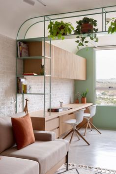 a living room filled with furniture next to a window covered in plants and greenery