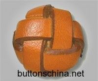 an orange is wrapped in brown leather