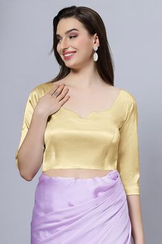 Our Satin Comfort Stretch collection blouses are made to impress and made to be worn all day. Made from the finest satin-cotton blend stretchable fabric, it holds its shape and shine while offering the comfort of stretchable material. Wear it with your favorite saree, as a crop top or lehenga choli! Item Type: Saree blouse / Crop top Product Features: Color: Gold Fabric: Satin Stretch Trim: Back Dori Neck Style: Leaf, Front & Back Sleeve Length: Elbow Sleeve Closure: Back Hook Padded: No Occasio Elegant Satin Blouse Piece With Padded Blouse, Fitted Satin Tops In Solid Color, Elegant Satin Padded Blouse Piece, Fitted Solid Satin Tops, Fitted Party Blouse In Solid Color, Elegant Satin Blouse Piece With Padding, Fitted Satin Blouse, Fitted Gold Padded Blouse, Elegant Stretch Gold Top