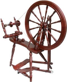 an old spinning wheel with wooden spokes on it's wheels is shown against a white background