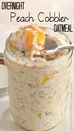 overnight peach cobbler oatmeal in a glass jar with a spoon on top