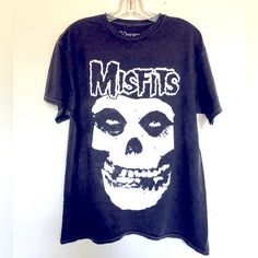 a black t - shirt with a skull on the front and words misfis printed on it