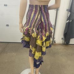 Handmade one-of-a-kind waterfall skirt. Layers and layers of mixed fabric, lace, and stitching were incorporated to create this piece of wearable art. The top part of the skirt reminds me of a bodice or corset just lower. It's even lined. It's shabby-chic and is truly amazing! The main colors are purples, yellows, and blues. There is a maker tag, "MACHINE". Very unique, and a little chaotic! The fit is most likely XS to S, and measures 34" long in the back, 14" on the front, 25" waist, zippered down the back.  This item has been used and loved and it has a history. Every attempt is made to describe it accurately, please examine photos carefully. Item is in overall very good condition for its age; the body maintains a lot of luster and sheen. We do not attempt to clean or otherwise alter ou Fitted Bohemian Skirt With Ruffles, Fitted Patchwork Tiered Skirt, Fitted Multicolor Asymmetrical Skirt, Fitted Dresses With Layered Hem Long Skirt, Bohemian Tiered Skirt With Attached Cancan, Bohemian Purple Ruffled Skirt, Fitted Bohemian Skirt With Attached Cancan, Bohemian Fitted Dress With Asymmetrical Skirt, Fitted Bohemian Dress With Asymmetrical Skirt