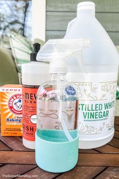 several bottles of cleaning products on a wooden table