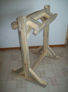 a wooden table that has been made out of some kind of wood and is sitting on the floor