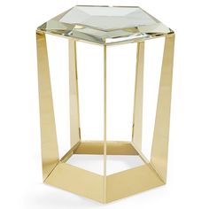 a gold metal and glass side table on a white background with no people around it