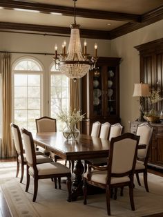 a dining room table with chairs and a chandelier