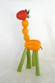 a plastic chair made to look like a strawberries and carrot sitting on top of each other