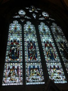 a large stained glass window inside of a church