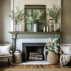 a living room with a fire place and flowers in vases on the mantel