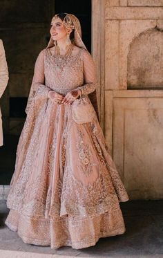 a woman in a wedding dress standing next to a man