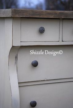 an old dresser with knobs and drawers is painted in antique white, while the drawer pulls open