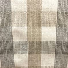 an upholstered checkered fabric with white and grey stripes