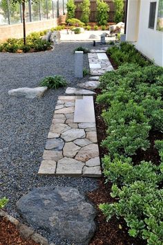 a stone path in the middle of a garden