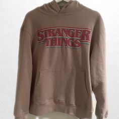 Old Navy Stranger Things Hooded Sweatshirt | Women’s Size Medium | New With Tags Hooded Brown Tops With Letter Print, Brown Hooded Tops With Letter Print, Brown Letter Print Hooded Top, Brown Hooded Top With Letter Print, Stretch Cotton Hoodie With Graphic Print, Cotton Stretch Hoodie With Graphic Print, Stranger Things Hoodie, Nasa Hoodie, Casual Logo