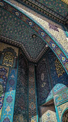 the inside of an ornate building with blue and green tiles on it's walls