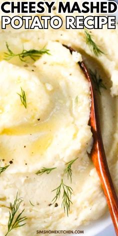 mashed potatoes in a white bowl with a wooden spoon and text overlay that reads cheesy mashed potato recipe