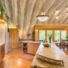 a large kitchen with wooden floors and walls