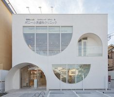 a white building with three circular windows on the front