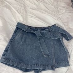 Brand New With Tags! Size Small, True To Size! Comfortable Denim Material! Has Pockets And Zips On The Side! Has A Wrap Around Belt That Can Be Tied Tighter! Shorts In The Back! Super Cute To Dress Up Or Down! It Is The Perfect Length, Not Too Short And I Am 5’3! Mid-rise Denim Blue Jean Shorts With Belt Loops, Mid-rise Denim Shorts With Belt Loops, Light Wash Denim Shorts With Belt Loops, Denim High-waisted Shorts For Day Out, Trendy Blue Jean Shorts With Belt Loops, Denim Blue High-waisted Shorts For Day Out, High-waisted Denim Blue Shorts For Day Out, High Waist Dark Wash Bottoms For Day Out, Denim Shorts For Day Out