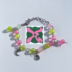 ★彡An adjustable bracelet inspired by TXT's 5th EP "The Name Chapter: Temptation". ★彡The bracelet in the pic has 14 beads, including a green and a pink bead as charms. ★彡Try NOT to expose the bracelet to water, like wearing it to the beach or showering with it. ★彡If you have any suggestions or questions, feel free to message me. I would be more than happy to help! Trendy Metal Beaded Bracelets, Trendy Metal Beaded Bracelets For Friendship, Y2k Style Adjustable Silver Bracelets, Adjustable Silver Y2k Bracelets, Adjustable Silver Y2k Style Bracelets, Handmade Y2k Style Bracelets Gift, Y2k Style Beaded Bracelets As Gift, Handmade Adjustable Y2k Beaded Bracelets, Txt Bracelet