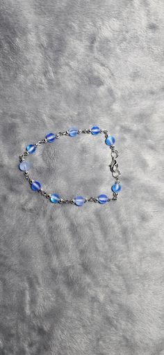 Frosted blue glass beaded bracelet with silver accents Blue Glass Bracelet Jewelry, Nickel-free Blue Metal Beaded Bracelets, Elegant Blue Glass Bracelet, Adjustable Nickel-free Blue Chain Bracelet, Nickel-free Blue Recycled Glass Jewelry, Glass Beaded Bracelets, Silver Accents, Blue Glass, Arm Band