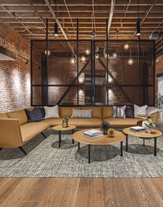 a living room filled with lots of furniture and decor on top of hard wood flooring