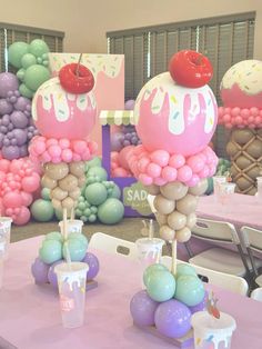 there are balloons and desserts on the tables