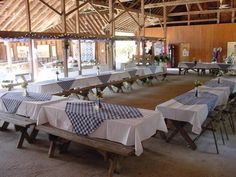 tables and chairs are set up in an old barn