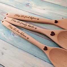 three wooden spoons with engraved names on them