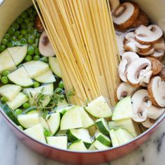 pasta and vegetables being cooked in a pot