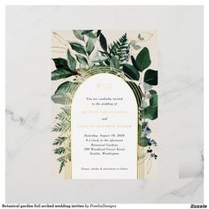 an elegant wedding card with greenery and gold foil on the front, in white marble