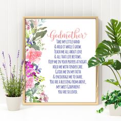 a framed print with the words godmoter on it next to potted plants