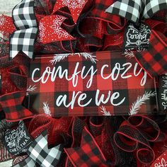 a red and black wreath with the words, comfy cozy are we on it