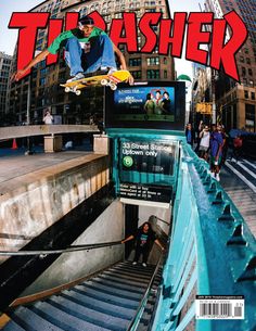 a man riding a skateboard down the side of a metal hand rail in front of a building