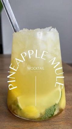 a glass filled with lemonade sitting on top of a wooden table