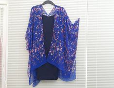 "This versatile kimono cardigan can be worn as a beach cover-up or with a  dress or camisole. Suitable for daywear or eveningwear, the perfect addition to any wardrobe.  Ideal for holidays and travelling, even backpacking as it takes up nearly no room in your travel bag and is light. - Blue Kimono Cardigan  - Wide Sleeves - Draping perfectly - Light weight sheer soft fabric - One size fits most - Floaty fabric - Light and breathable - V neck style at the back *Please note the dress is not includ Blue Kimono With Kimono Sleeves For Daywear, Bohemian Blue Kimono For Daywear, Blue Bohemian Kimono For Daywear, Blue Spring Kimono For Daywear, Floral Print Shawl Kimono For Spring, Spring Floral Print Shawl Kimono, Blue Kimono For Spring Daywear, Blue Kimono For Daywear In Spring, Spring Shawl Kimono With Floral Print