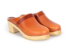 Our popular Stockholm clogs in cognac brown pull up leather. The clogs are made on our varnished Mid heel wooden base which makes them great companions for most seasons.Heel height: 7 cmPlatform height: 2.5 cmFit: Narrow to medium widthLeather Upper: Cognac pull upWood: Varnished alderwoodFootbed: Natural alderwood for excellent moist absorption*Maguba Size Guide*EUR 35 | USA 5-5.5 (227mm | 8.94 inches)EUR 36 | USA 6-6.5 (233mm | 9.17 inches)EUR 37 | USA 7-7.5 (240mm | 9.45 inches)EUR 38 | USA 8 Orange Leather Round Toe Clogs, Brown Clogs With Leather Lining And Round Toe, Classic Brown Clogs With Leather Lining, Orange Leather Closed Toe Clogs, Orange Closed Toe Leather Clogs, Orange Leather Clogs, Classic Brown Clogs With Rubber Sole, Classic Brown Clogs With Leather Sole, Brown Closed Toe Clogs With Leather Lining