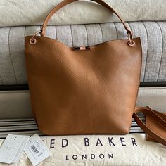 Pristine Used Condition. Purchased From Ted Baker At Lhr. Used A Few Times. This Shoulder Bag Easily Converts To A Crossbody With Tons Of Room For All Your Essentials. Pretty Rose Gold Hardware. Sleek And Sophisticated, The Candiee Bag Is A Stylish Way To Transport Your Everyday Essentials. Crafted From Sumptuous Leather, It’s Sure To Become Your New Favourite Companion. Leather Top Handle Internal Zip Compartment Detachable Inner Bag Clasp Fastening Detachable Shoulder Strap Ted Baker-Branded D Everyday Caramel Shoulder Bag With Detachable Strap, Cognac Bucket Bag In Textured Leather, Caramel Leather Shoulder Bag With Removable Pouch, Brown Textured Leather Bucket Bag For Shopping, Everyday Caramel Shoulder Bag With Leather Lining, Caramel Bag With Adjustable Strap For Everyday, Everyday Caramel Bag With Adjustable Strap, Brown Textured Leather Top Handle Bucket Bag, Brown Textured Leather Shoulder Bag For Errands