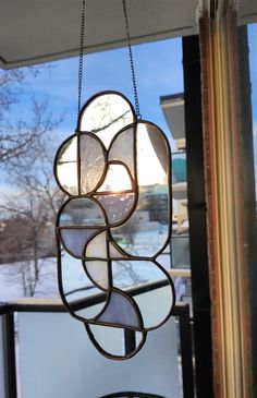 a stained glass window hanging from the side of a building