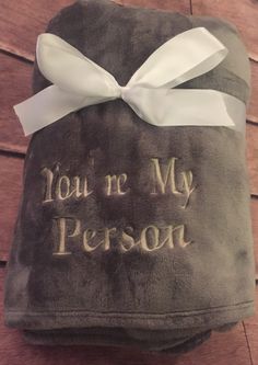 a towel with the words you're my person on it and a white bow