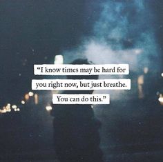 a person standing in front of a street at night with the words, i know times may be hard for you right now, but just breathe