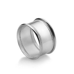 a white gold wedding ring with two rows on the side and an engraving pattern in the middle